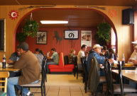 Interior of 7 Leguas Mexican Grille showing warm arched cantina space with diners enjoying authentic Mexican food
